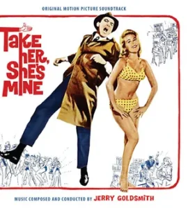 Movie poster for 'Take Her, She's Mine' featuring a man in a brown coat kicking beside a woman in a yellow polka-dot bikini, with bold red title text.