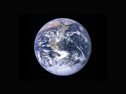 Earth as seen from space, showing continents and cloud patterns against a black background.