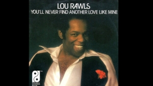 Album cover showing Lou Rawls smiling in a white shirt with a black vest and red boutonniere; title at top reads 'LOU RAWLS YOU'LL NEVER FIND ANOTHER LOVE LIKE MINE'.