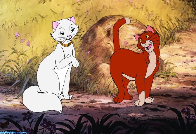 Two cartoon cats stand in a sunny field: a white cat with a collar and a shy pose beside an orange cat who smiles and arches its back.