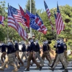 Masked men with confederate flags march through DC on July 4